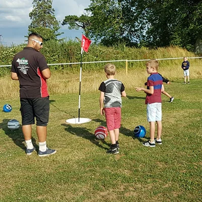 A family enjoying footgolf in the grounds of Escot Park