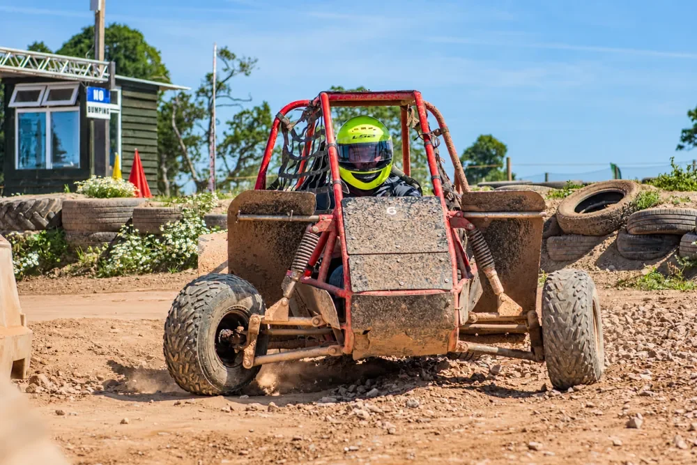 A driver enjoying off-road karting on the outdoor track at Escot Park