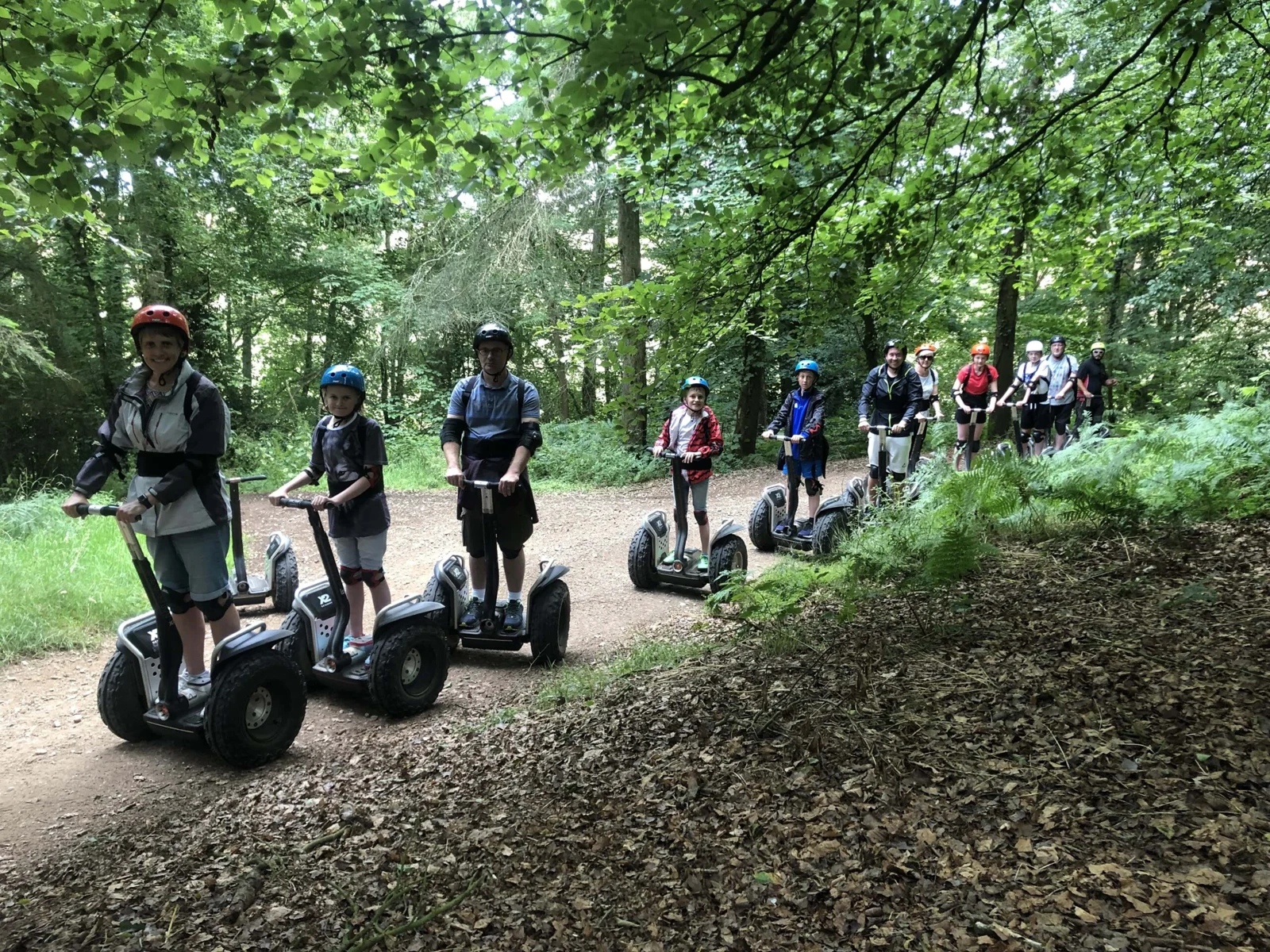 A group following a Segway trail through the woods